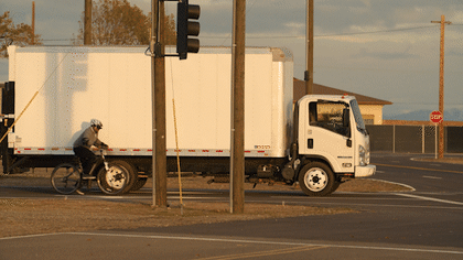 A test scenario with a cyclist coming from behind a parked truck. We only stage scenarios with real agents after taking appropriate safety precautions and use mannequins or create scenarios via fully synthetic means for more dangerous situations.