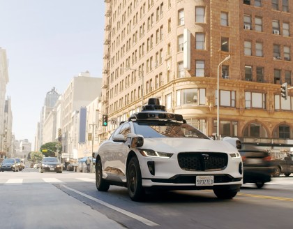 Waymo vehicle driving on busy city street