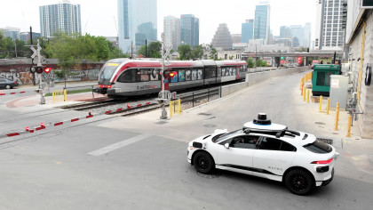 Waymo vehicle in Austin, Texas waiting at a train crossing.