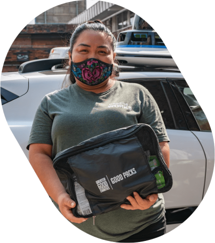 Greater Good partner in front of Waymo vehicle